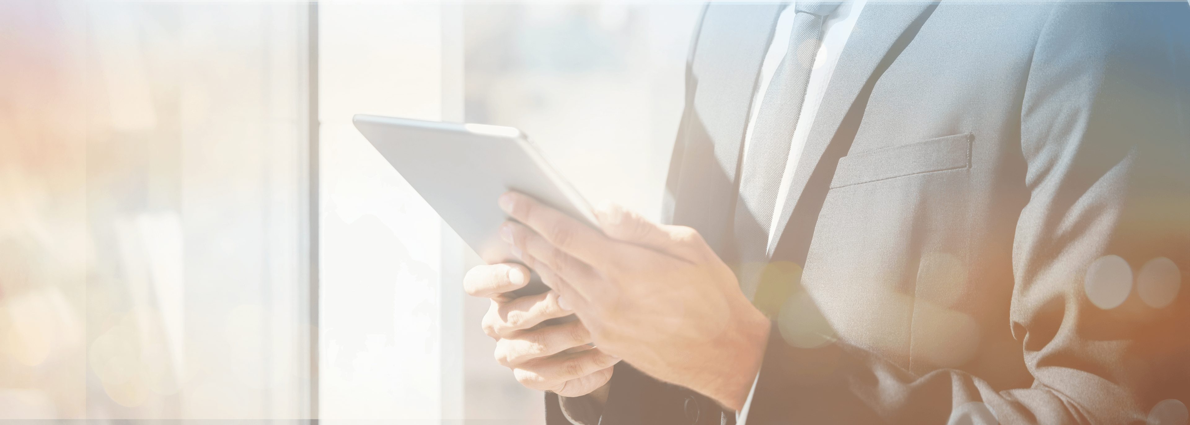 Men in suit reading from tablet